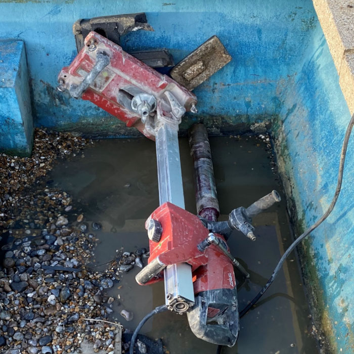 core drilling in a old pool with stones