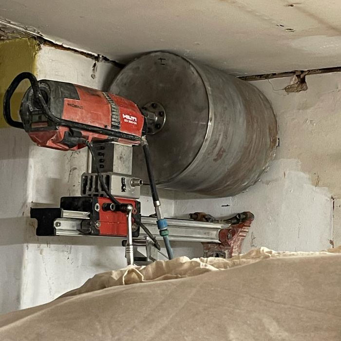 massive core diamond drill cutting large hole in wall